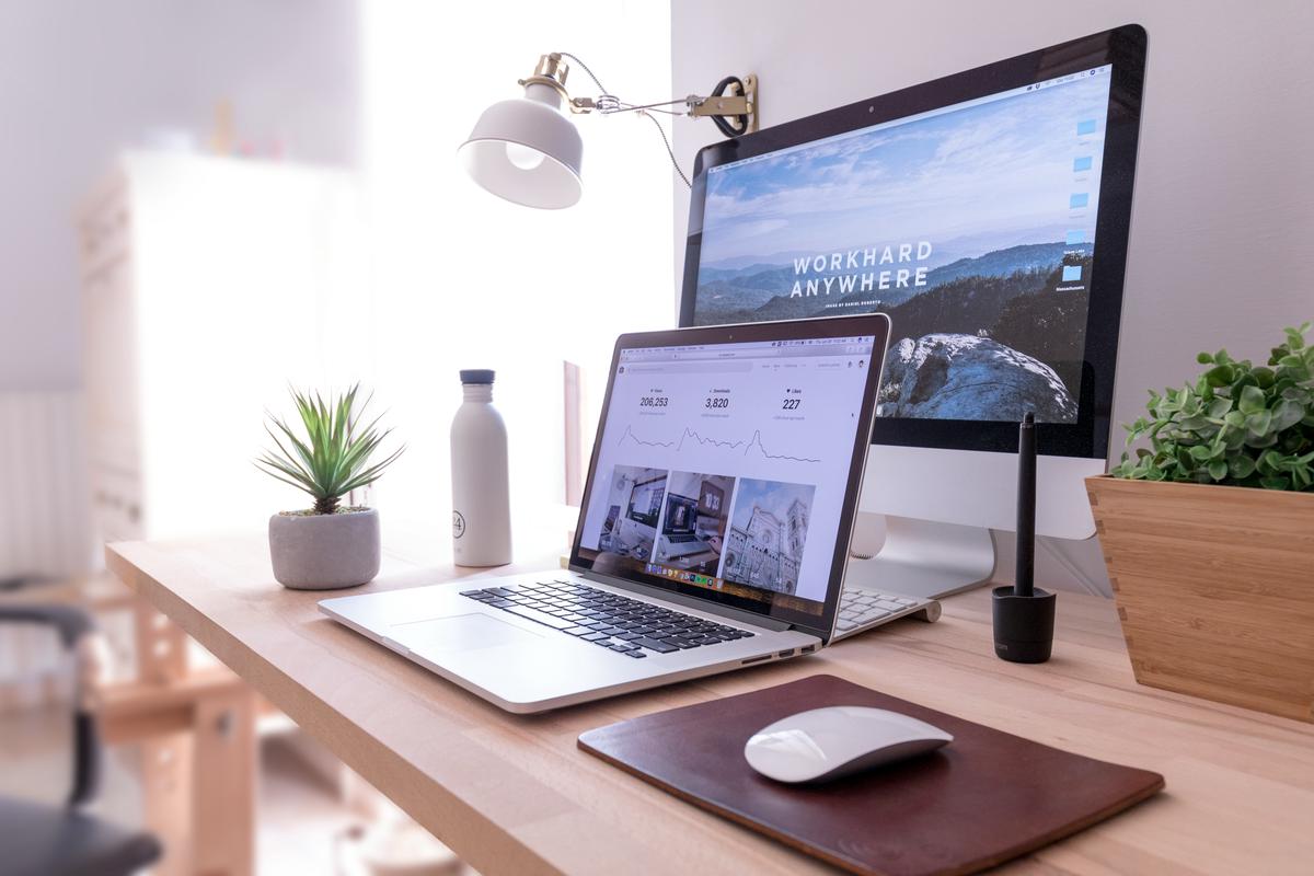 An image of a futuristic office with employees working together on tech devices